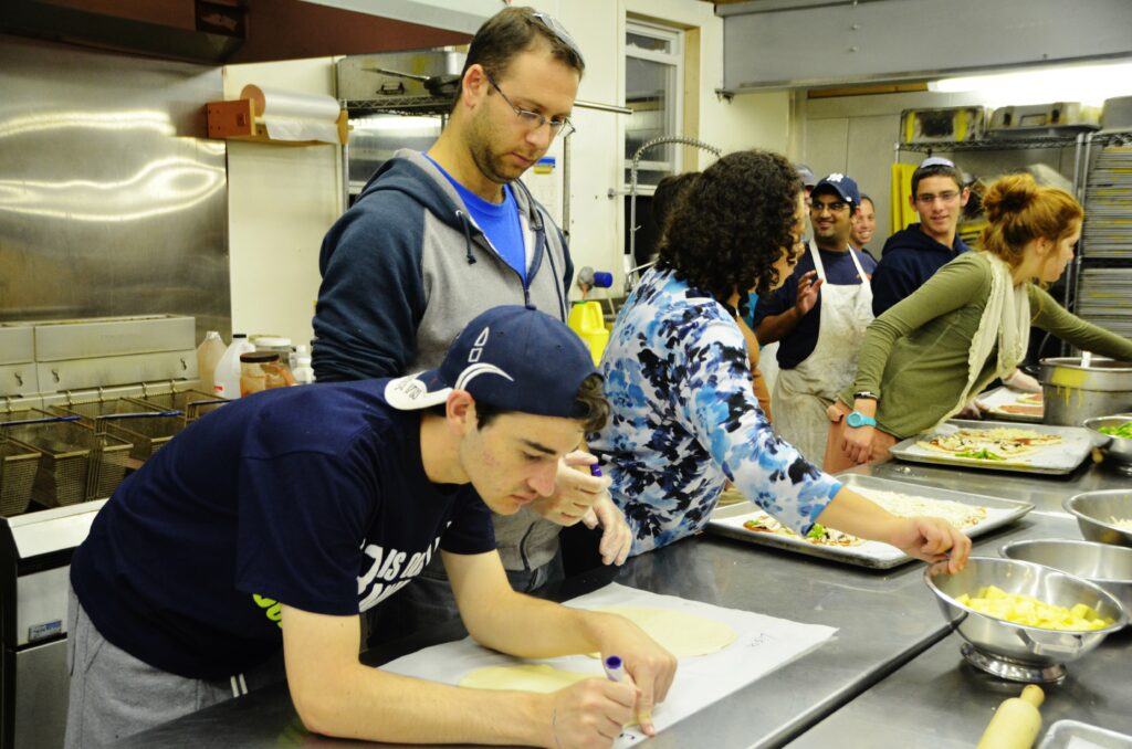 Making pizzas in the Camp Moshava Kitchen