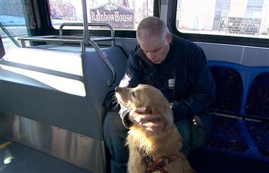 Harold Leigland, who is blind, with his guide dog on the bus during his morning commute to the Goodwill facility in Great Falls, Montana, where he works hanging clothing.