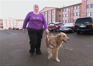 Sheila Leigland, who is blind, with her guide dog. She quit her job at Goodwill in Great Falls, Montana, after her hourly wage was lowered to $2.75.